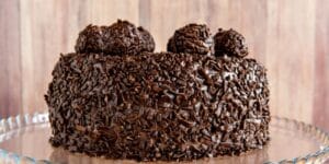 Brigadeirão de Chocolate cremoso decorado com granulado, servido em prato branco