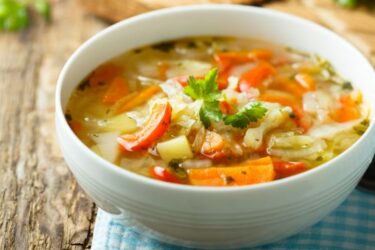 Sopa de legumes caseira servida em um prato fundo