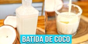 Batida de Coco cremosa em copo com gelo, coco ralado e pedaços de coco.