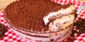 Pavê de café com cream cheese servido em taças decoradas.