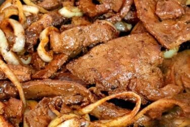 Bife de fígado acebolado com cebolas douradas em frigideira