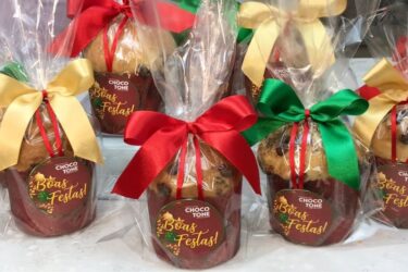 Mini chocotones de Natal dourados com gotas de chocolate.