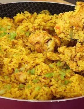 Arroz com frango cremoso e colorido servido em uma panela rústica