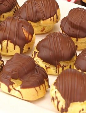 Carolinas recheadas com creme e cobertas com chocolate